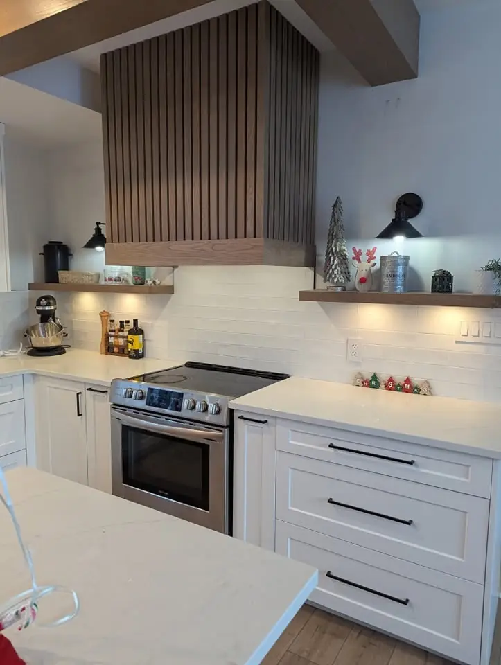 Renovated kitchen with under-cabinet lighting and black wall sconces