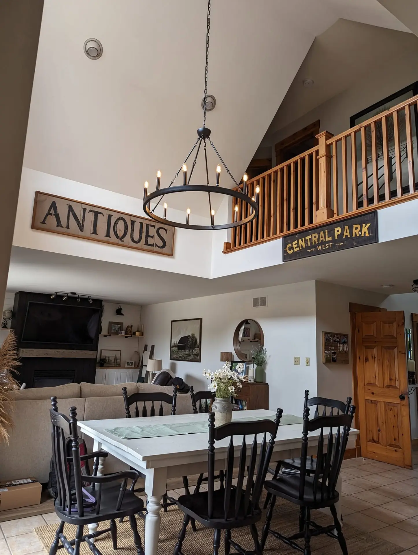 Open living and dining room with a large ring chandelier